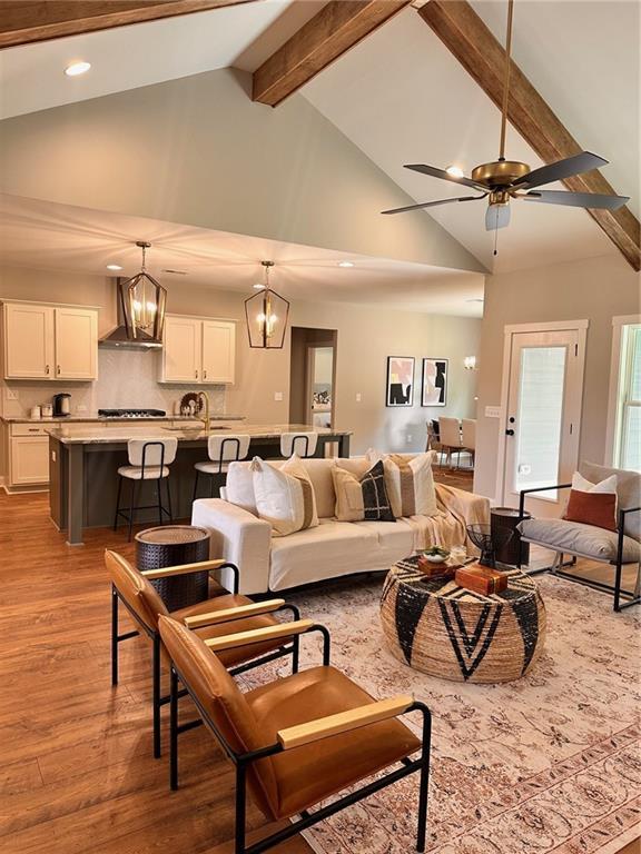 101 Red Oak Ln, Carrollton, GA 30116 - living room featuring high vaulted ceiling, beam ceiling, wood finished floors, a chandelier, and recessed lighting