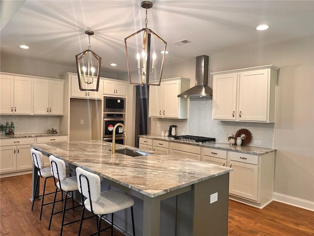 101 Red Oak Ln, Carrollton, GA 30116 - kitchen with wall chimney range hood, stainless steel appliances, a sink, recessed lighting, and dark wood finished floors