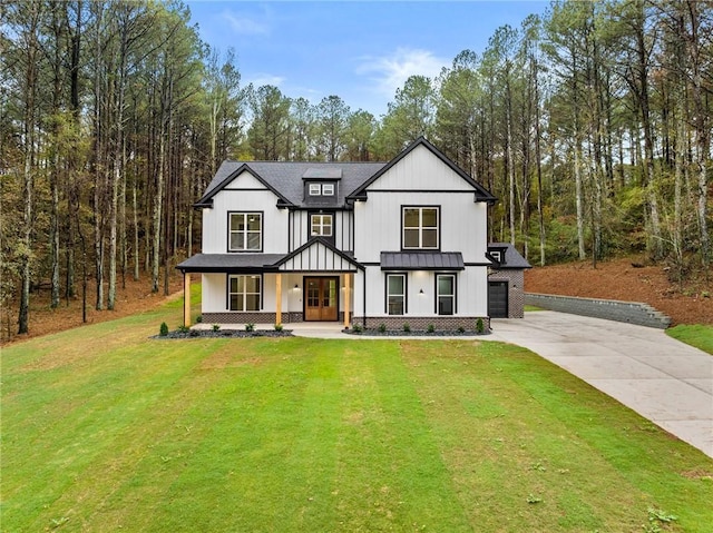 modern farmhouse style home with a porch, a garage, and a front yard