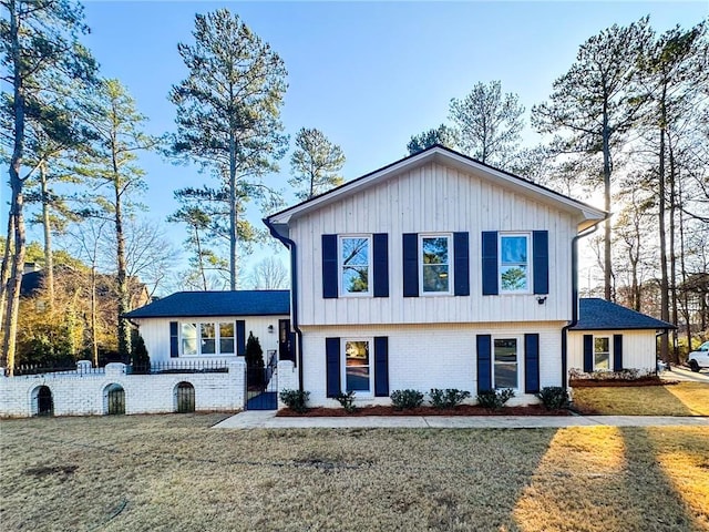 split level home featuring a front lawn