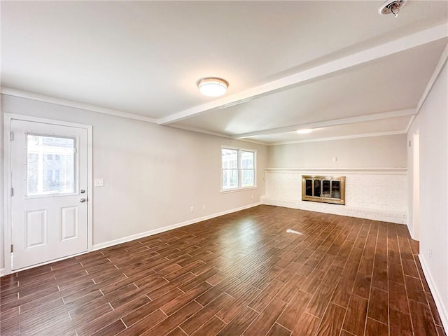 unfurnished living room featuring a brick fireplace, beam ceiling, and dark wood-type flooring