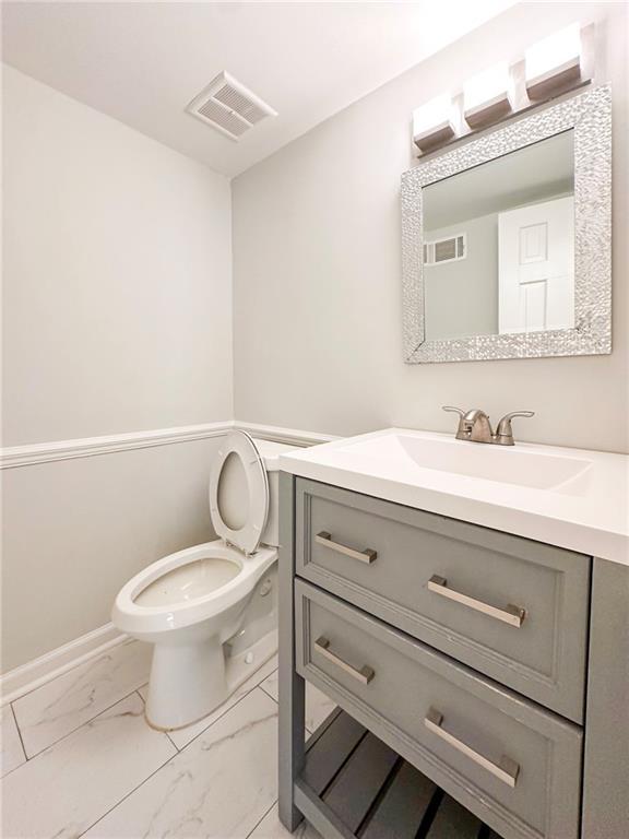 bathroom featuring vanity and toilet