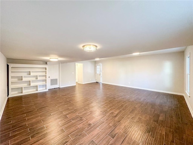 unfurnished living room with dark hardwood / wood-style floors