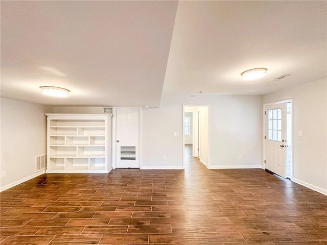 unfurnished living room with dark hardwood / wood-style flooring