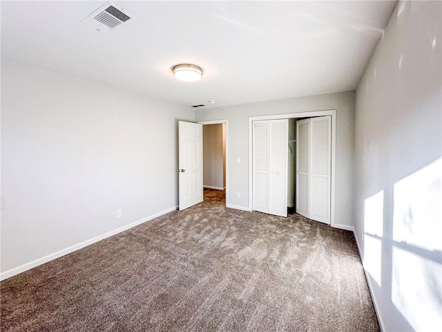 unfurnished bedroom featuring a closet and carpet