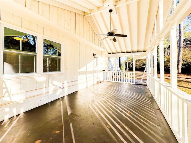 unfurnished sunroom featuring lofted ceiling and ceiling fan