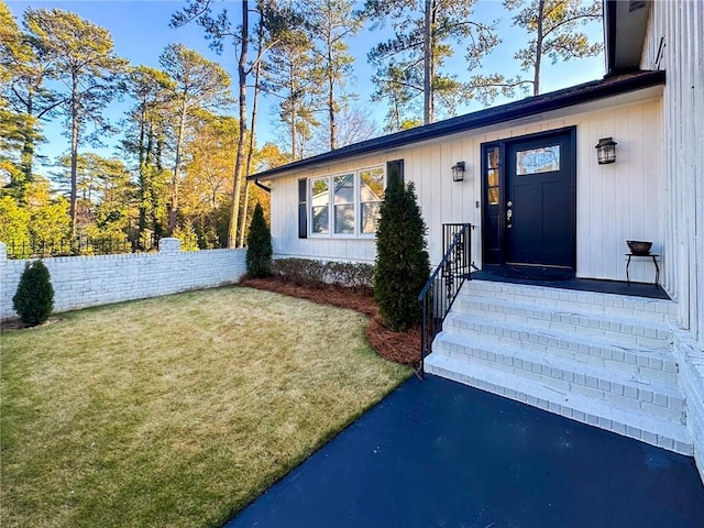 property entrance with a yard