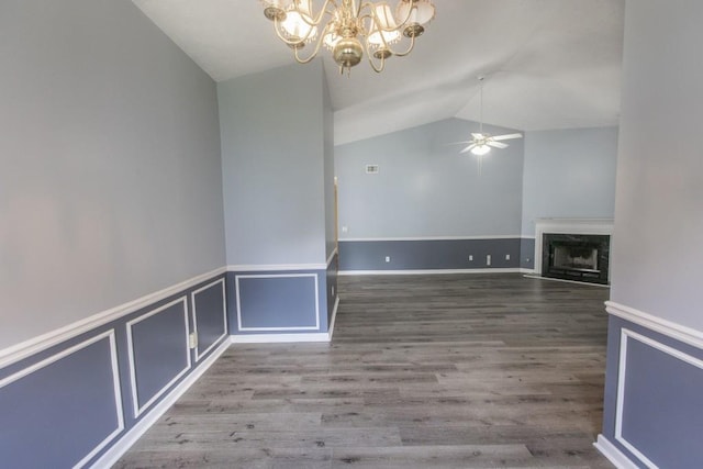 706 Hillmont Dr, Loganville, GA 30052 - unfurnished dining area with a chandelier, vaulted ceiling, ceiling fan, a fireplace, and wood finished floors