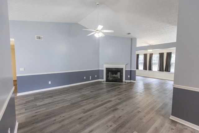 706 Hillmont Dr, Loganville, GA 30052 - unfurnished living room with lofted ceiling, ceiling fan, a high end fireplace, and wood finished floors