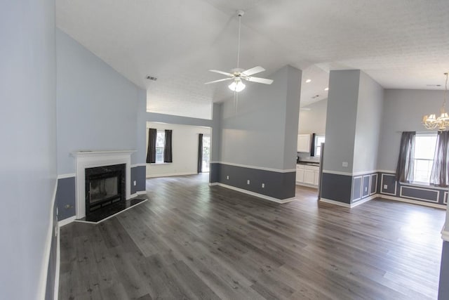 706 Hillmont Dr, Loganville, GA 30052 - unfurnished living room with a chandelier, a ceiling fan, dark wood-style floors, a fireplace, and high vaulted ceiling