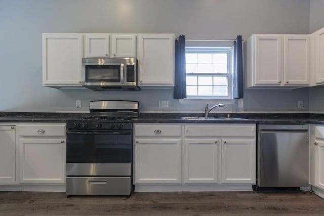 706 Hillmont Dr, Loganville, GA 30052 - kitchen featuring stainless steel appliances, white cabinetry, and dark wood-style flooring
