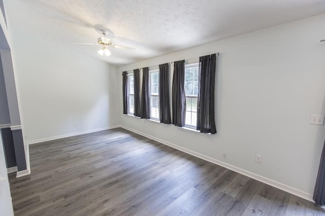 706 Hillmont Dr, Loganville, GA 30052 - empty room featuring dark wood-style flooring, ceiling fan, and a textured ceiling