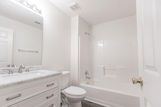 706 Hillmont Dr, Loganville, GA 30052 - bathroom featuring vanity, a textured ceiling, bathing tub / shower combination, and wood finished floors