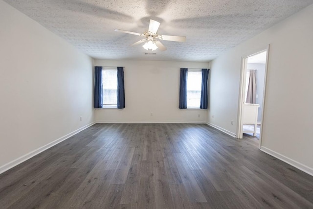 706 Hillmont Dr, Loganville, GA 30052 - empty room with healthy amount of natural light, a textured ceiling, dark wood finished floors, and a ceiling fan