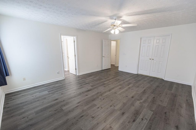 706 Hillmont Dr, Loganville, GA 30052 - unfurnished bedroom with dark wood-type flooring, a textured ceiling, a closet, and ceiling fan