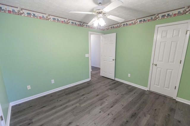 706 Hillmont Dr, Loganville, GA 30052 - unfurnished bedroom with wood finished floors, a textured ceiling, and ceiling fan