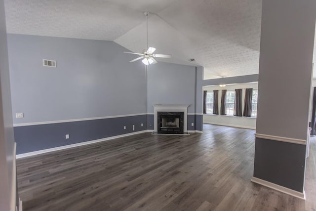 706 Hillmont Dr, Loganville, GA 30052 - unfurnished living room with ceiling fan, lofted ceiling, dark wood finished floors, a textured ceiling, and a high end fireplace