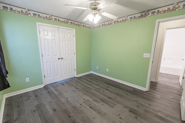 706 Hillmont Dr, Loganville, GA 30052 - unfurnished bedroom with a textured ceiling, wood finished floors, a closet, and ceiling fan