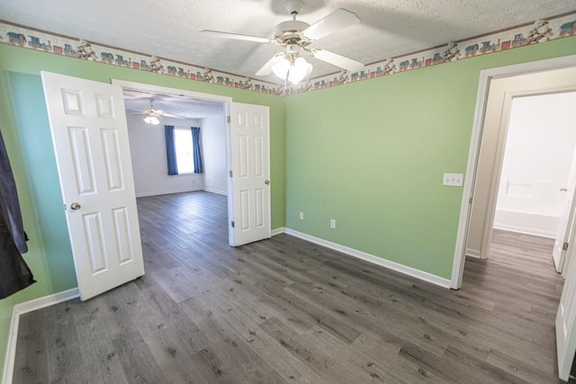 706 Hillmont Dr, Loganville, GA 30052 - empty room with a textured ceiling, wood finished floors, and ceiling fan