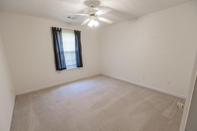 706 Hillmont Dr, Loganville, GA 30052 - empty room with a textured ceiling, light colored carpet, and a ceiling fan