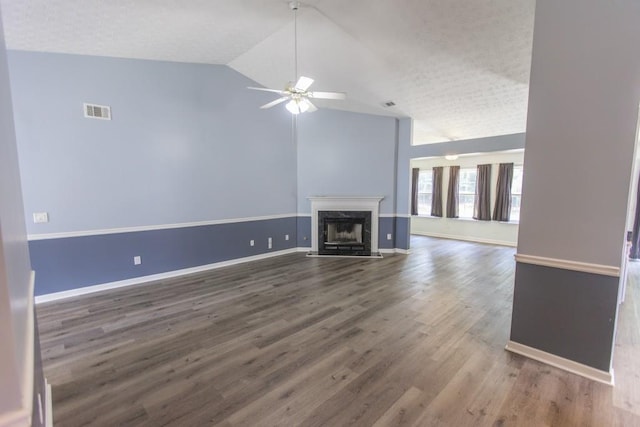 706 Hillmont Dr, Loganville, GA 30052 - unfurnished living room featuring lofted ceiling, a ceiling fan, a fireplace, wood finished floors, and a textured ceiling