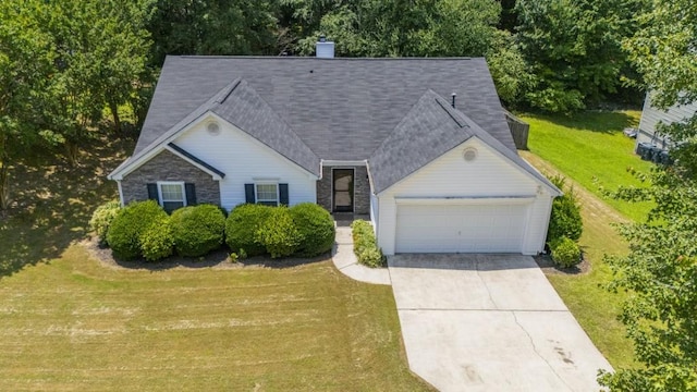 706 Hillmont Dr, Loganville, GA 30052 - view of front of property with an attached garage, a front lawn, concrete driveway, and a chimney