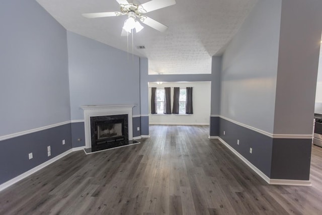 706 Hillmont Dr, Loganville, GA 30052 - unfurnished living room featuring wood finished floors, ceiling fan, a premium fireplace, vaulted ceiling, and a textured ceiling