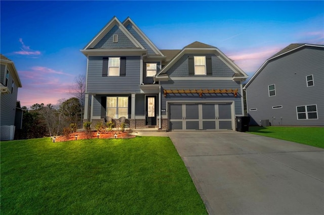 craftsman house featuring central AC, a yard, and a garage