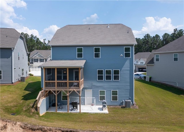 back of property featuring a yard, central AC, a patio area, and a sunroom