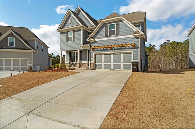 craftsman-style house featuring a garage and central AC unit