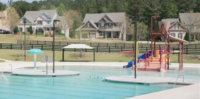 view of pool with a playground