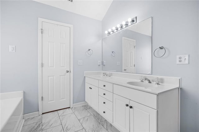 full bath with a sink, lofted ceiling, marble finish floor, and double vanity