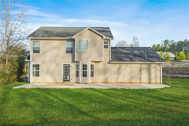 rear view of property with a patio and a yard