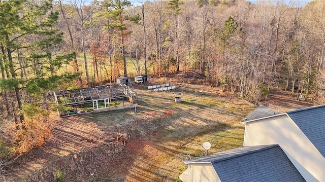 birds eye view of property with a forest view