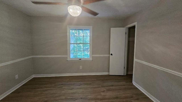 unfurnished bedroom with dark wood-style floors, baseboards, and a ceiling fan