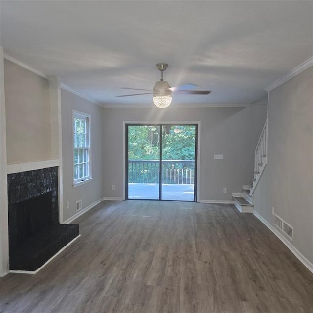 unfurnished living room featuring stairs, a fireplace, visible vents, and wood finished floors