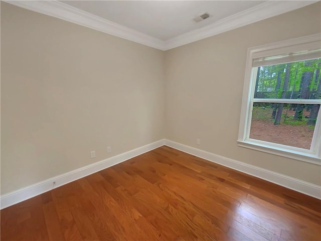 unfurnished room with wood-type flooring and ornamental molding