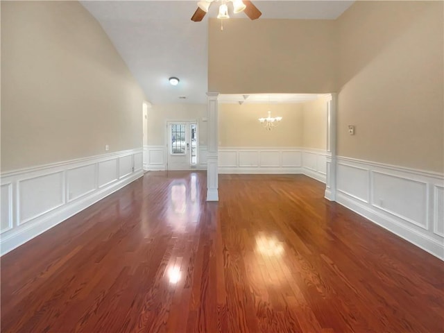 interior space featuring dark hardwood / wood-style flooring and ceiling fan with notable chandelier