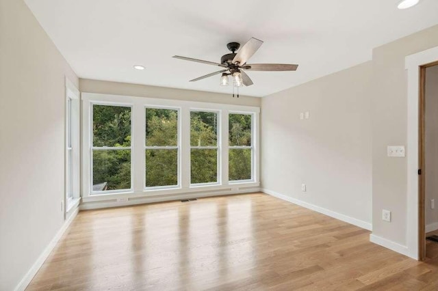 empty room featuring light hardwood / wood-style flooring and ceiling fan