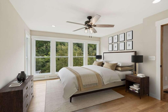 bedroom featuring light hardwood / wood-style flooring and ceiling fan