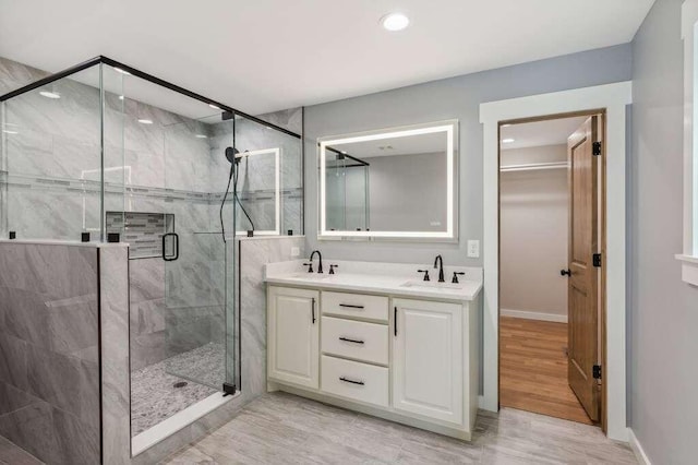 bathroom featuring vanity and a shower with shower door