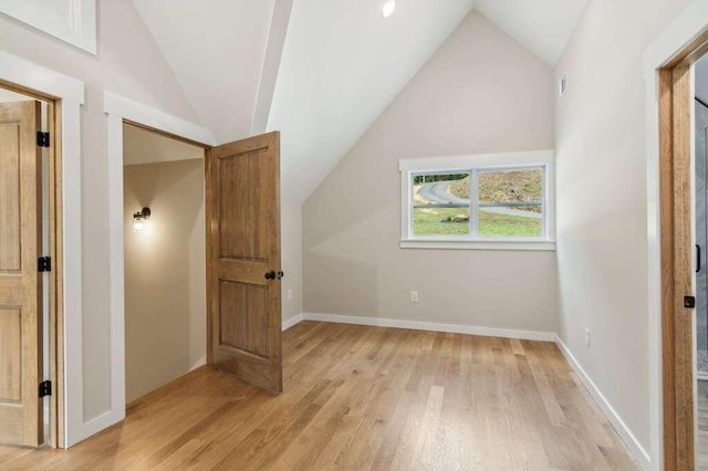 bonus room featuring lofted ceiling and light hardwood / wood-style flooring