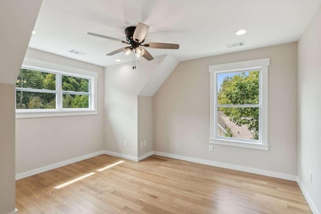 additional living space featuring a wealth of natural light, light hardwood / wood-style floors, and ceiling fan