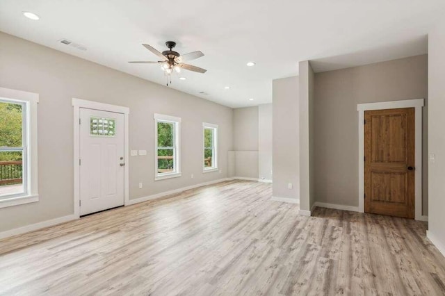 unfurnished living room with ceiling fan and light wood-type flooring