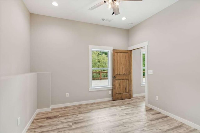 spare room featuring light hardwood / wood-style floors and ceiling fan