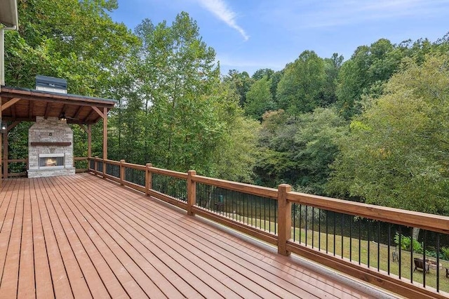 deck featuring an outdoor stone fireplace