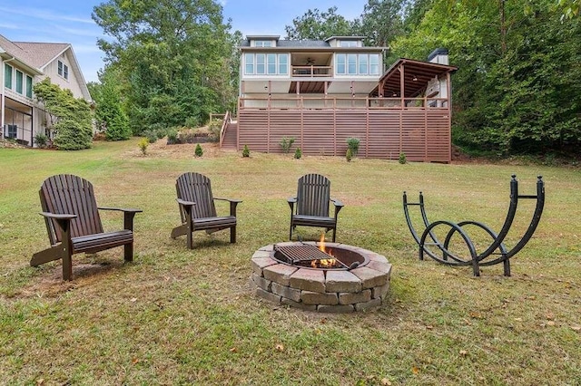 view of yard featuring a fire pit and a deck