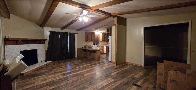 unfurnished living room with lofted ceiling with beams, ceiling fan, dark wood-type flooring, and a fireplace