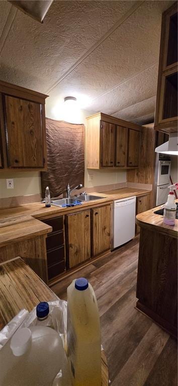 kitchen featuring white dishwasher, dark wood-type flooring, and sink