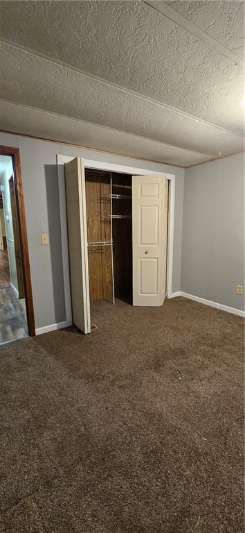 unfurnished bedroom with carpet floors and a closet